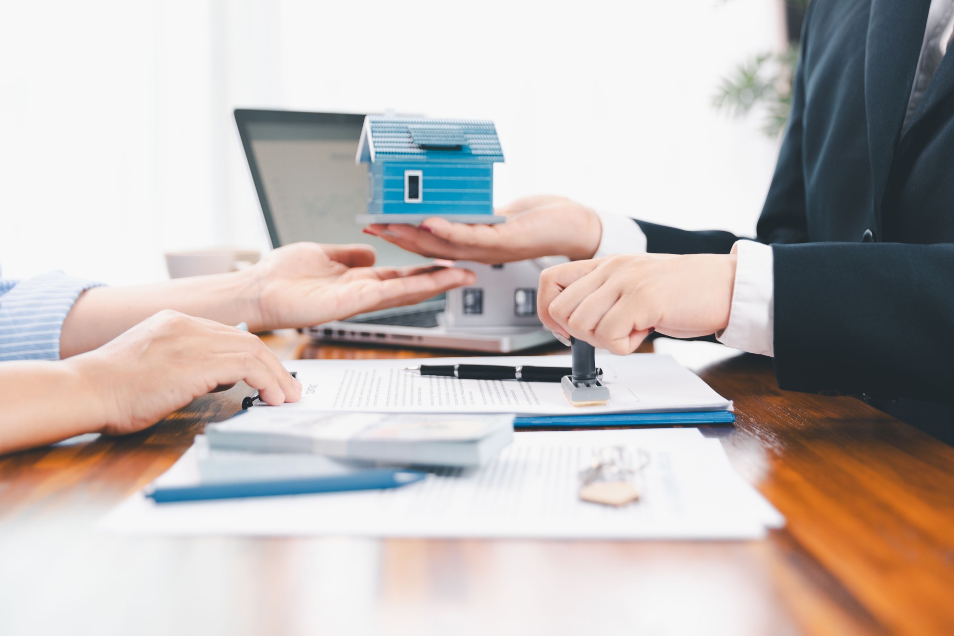 Bank approve loan to buy home concept. Real estate agent talked about terms of home purchase agreement, asked customer to sign documents to make contract legally. approved mortgage application form.